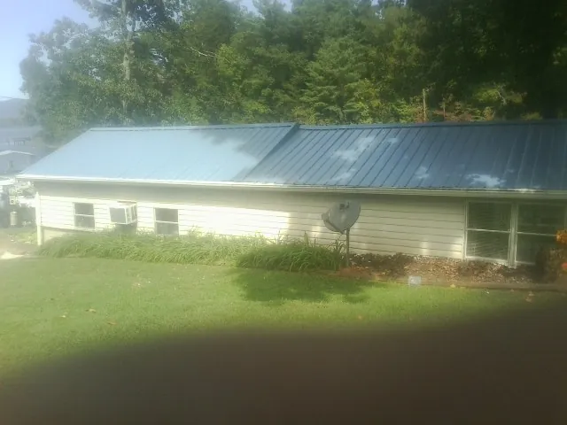 Blue metal roof running the length of a single story home in Hamer